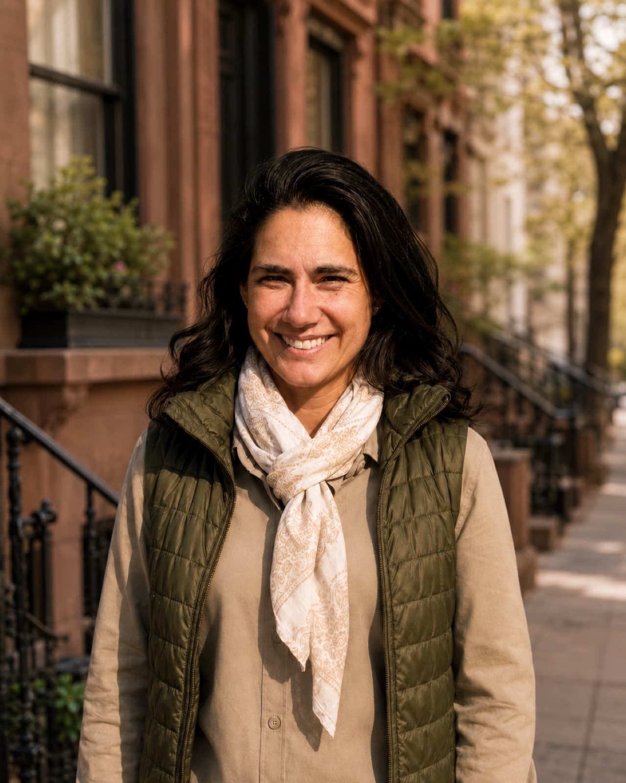 Candice, founder of Rhemaia, on a tree-lined brownstone street in warm afternoon light